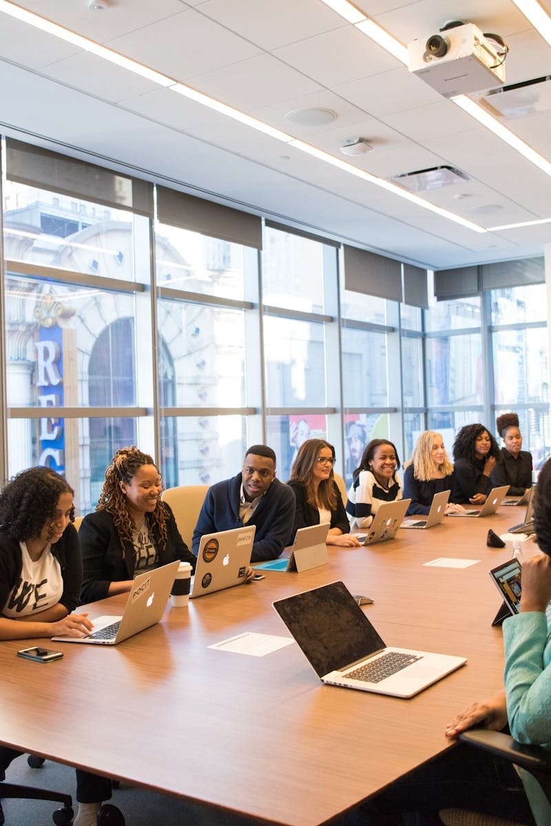 A diverse team of business professionals collaborating in a modern meeting room.